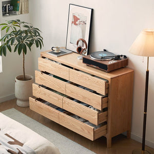 a record player sitting on top of a wooden dresser