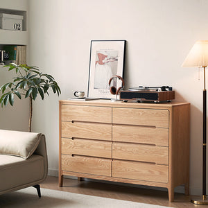 a living room with a couch and a dresser