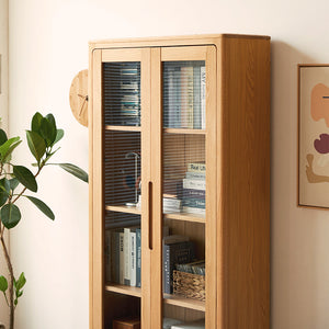 a wooden cabinet with glass doors next to a potted plant