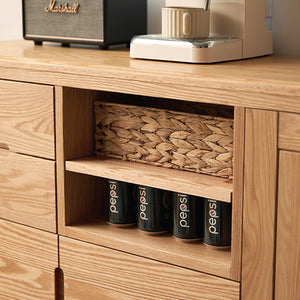 a wooden cabinet with four cans of coffee on top of it