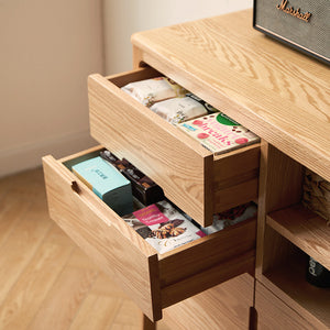 a wooden desk with drawers and a radio on top of it