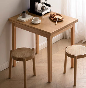 a small table with two chairs and a coffee maker