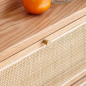 an orange sitting on top of a wooden dresser