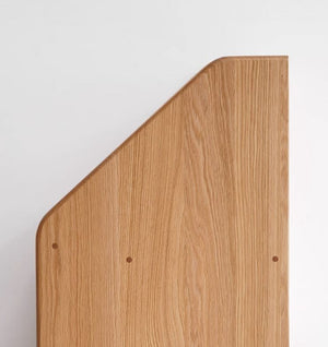 a corner of a wooden board with a white background