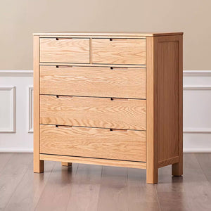 a wooden chest of drawers sitting on a hard wood floor