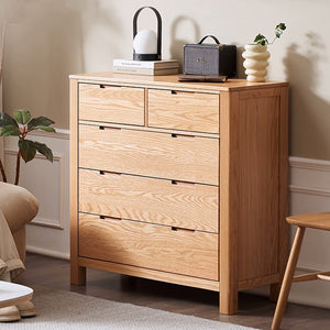 a wooden chest of drawers in a living room