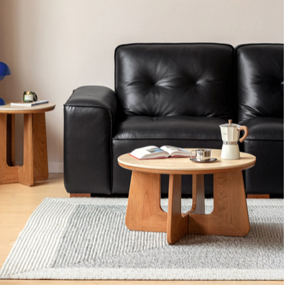 Anela natural solid cherry coffee table set with travertine-look sintered stone top in a modern organic Kiwi living room
