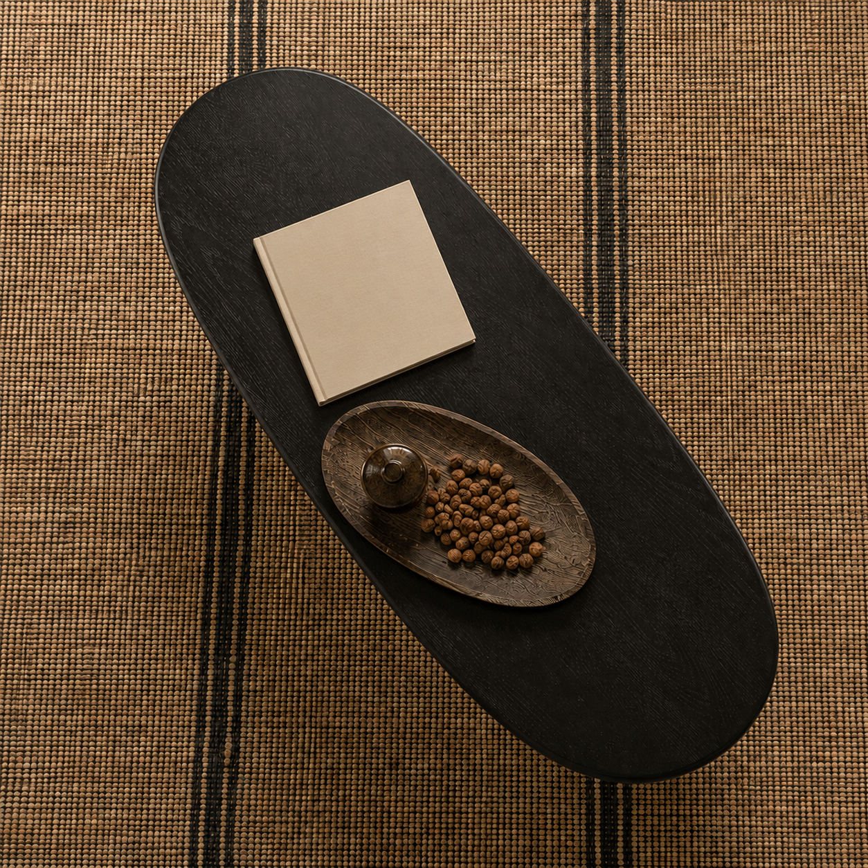 Top view of a black ash wood oval coffee table highlighting the elongated tabletop shape and dark wood grain.