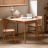 Bremen Natural Solid Oak Extending Dining Table styled with wooden chairs in a warm dining room