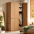 Clovis natural solid oak wardrobe with one door open showing hanging rail and storage shelves