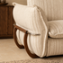 Cream striped fabric sofa with deep cushioned seating styled in a warm contemporary living room.