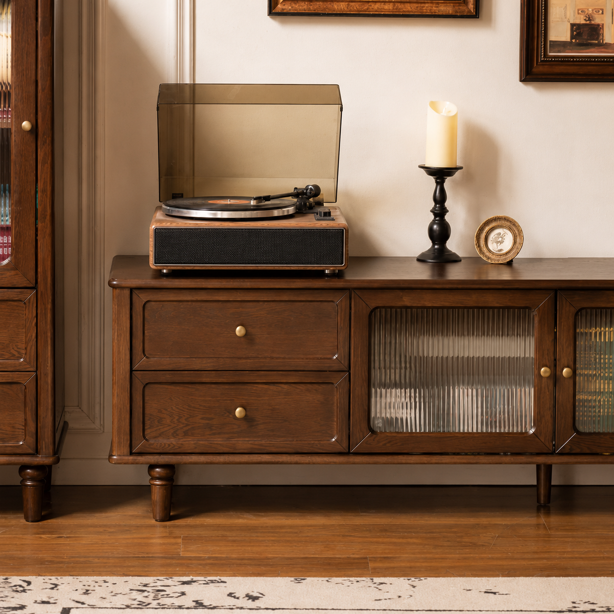 Close-up of the storage drawer on a dark wood TV unit with a brass knob and natural wood grain.