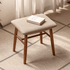 Graz natural solid walnut dressing stool with beige upholstered seat styled on a neutral bedroom rug
