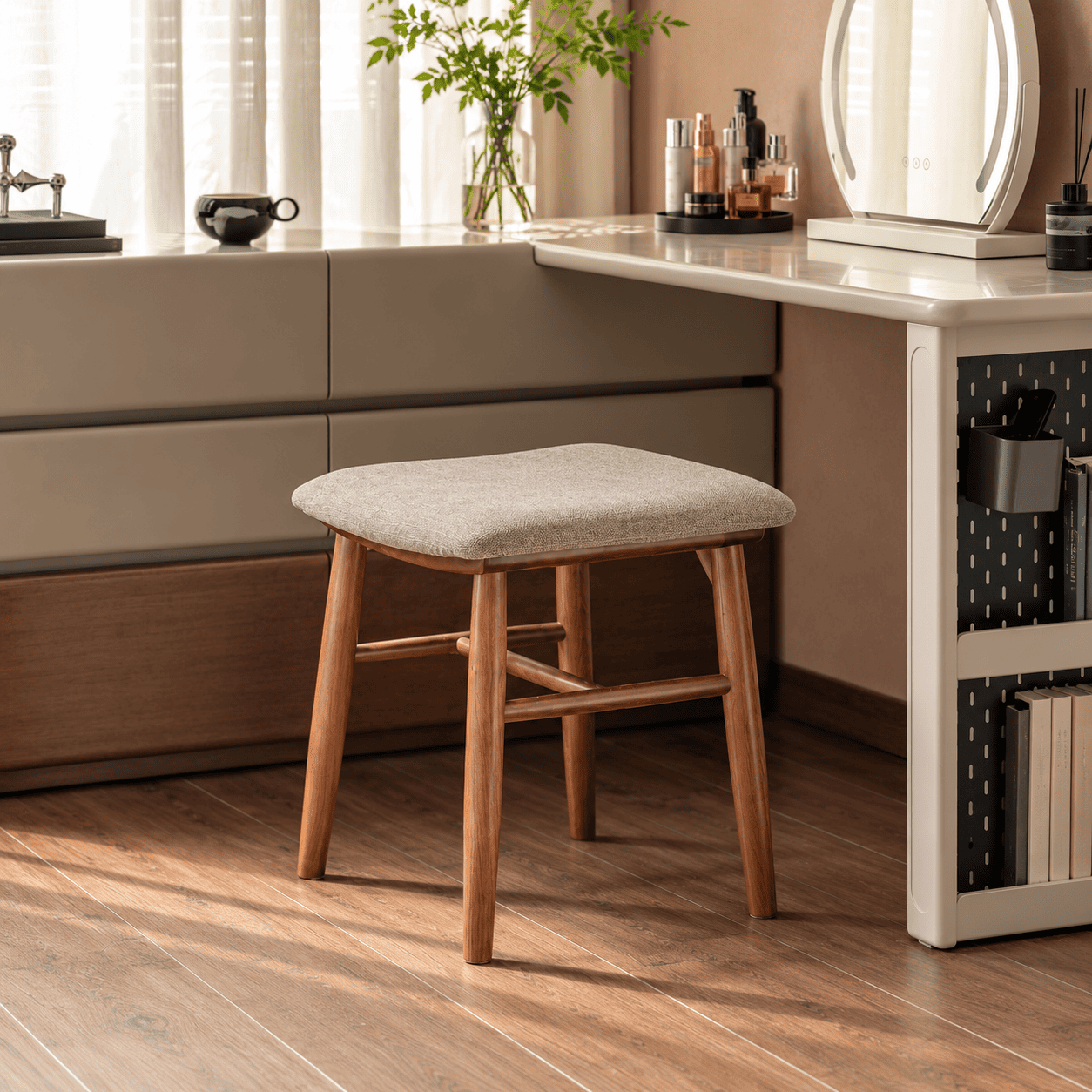Graz solid walnut dressing stool with upholstered seat styled beside a modern dressing table