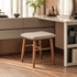 Graz solid walnut dressing stool with upholstered seat styled beside a modern dressing table