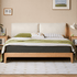 Scandinavian-style wooden bed frame with a cream upholstered headboard and natural oak finish.