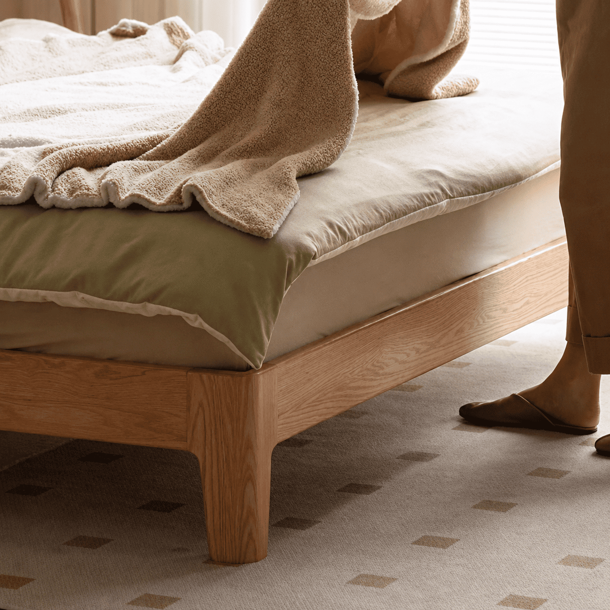 Solid oak bed frame with a cream upholstered headboard and minimalist contemporary design.