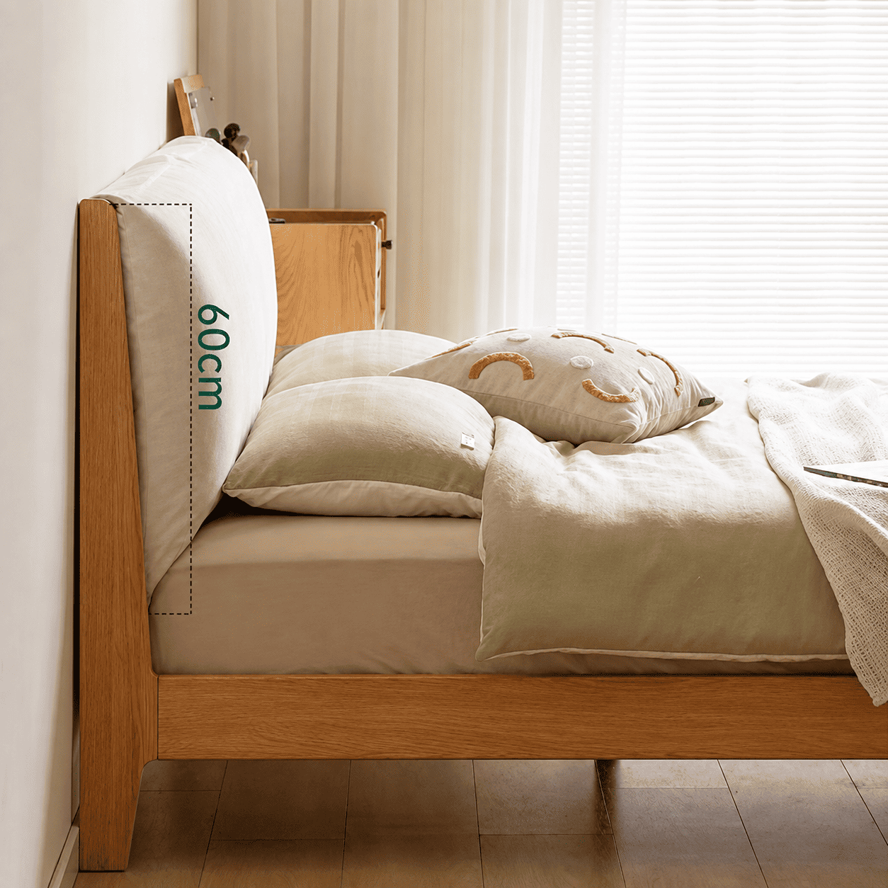 Light oak bed frame with a soft upholstered headboard and contemporary minimalist styling.