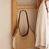 Close up of Kent natural solid oak coat rack side hook with woven shoulder bag