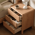 Kusel Natural Solid Oak Bedside Table showing rounded frame, side panel detail and clean three-drawer storage design.