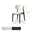 Upholstered dining chair with soft textured fabric, rounded seat, and solid oak charcoal legs