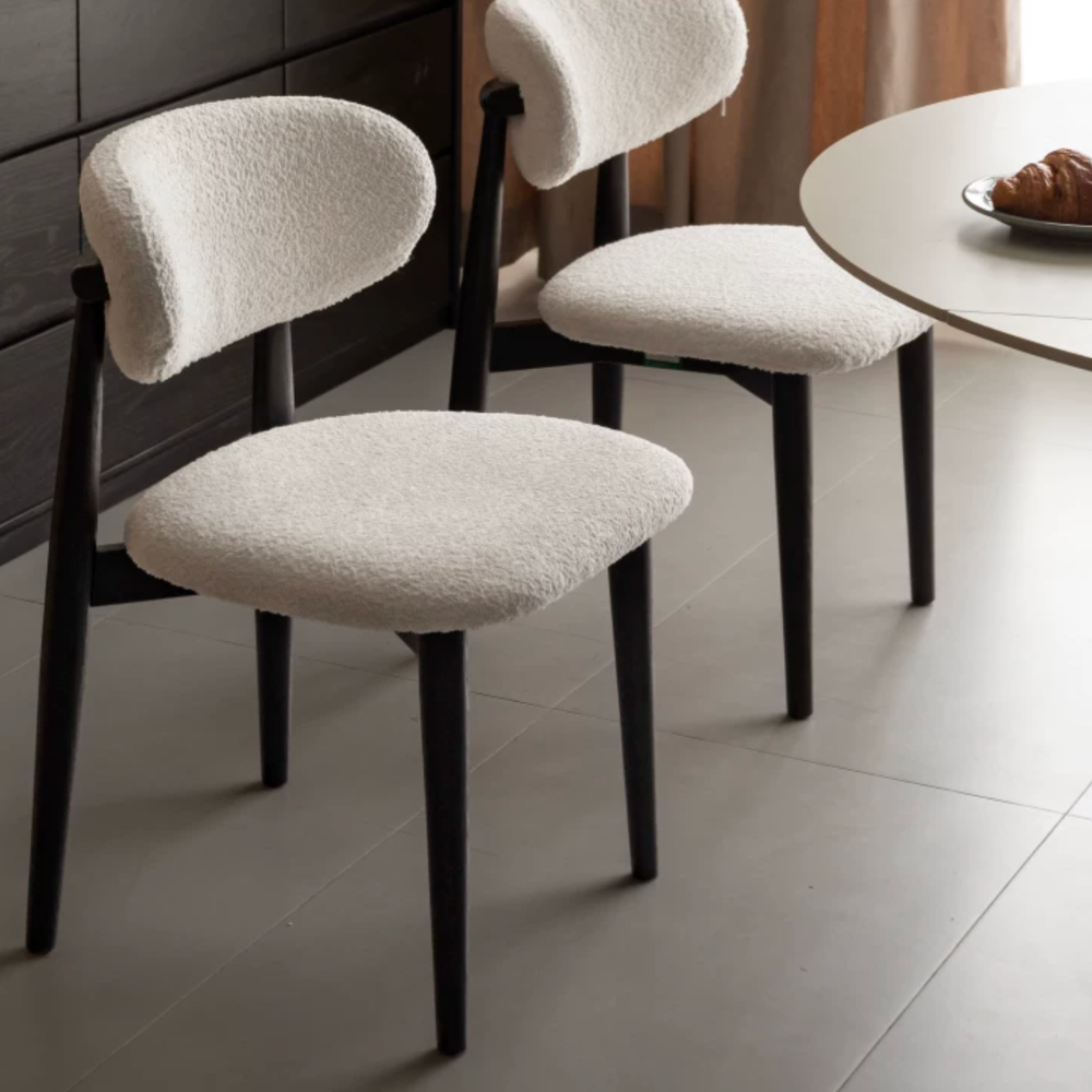 Solid oak dining chair with charcoal finish legs and textured fabric upholstery for modern dining rooms