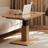 Linnich Natural Solid Ash Height Adjustable Coffee Table with lift-up rectangular tabletop, sturdy pedestal base and natural wood grain finish beside a cream sofa in a modern living room.
