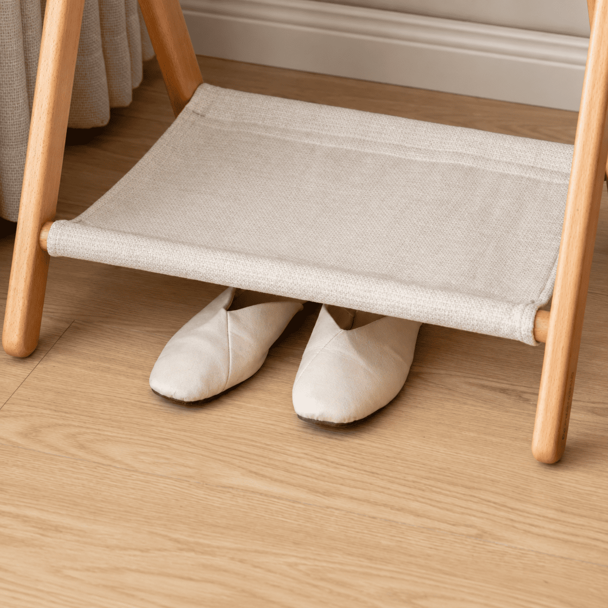 Close-up of Naila coat rack lower fabric shelf with slippers stored underneath