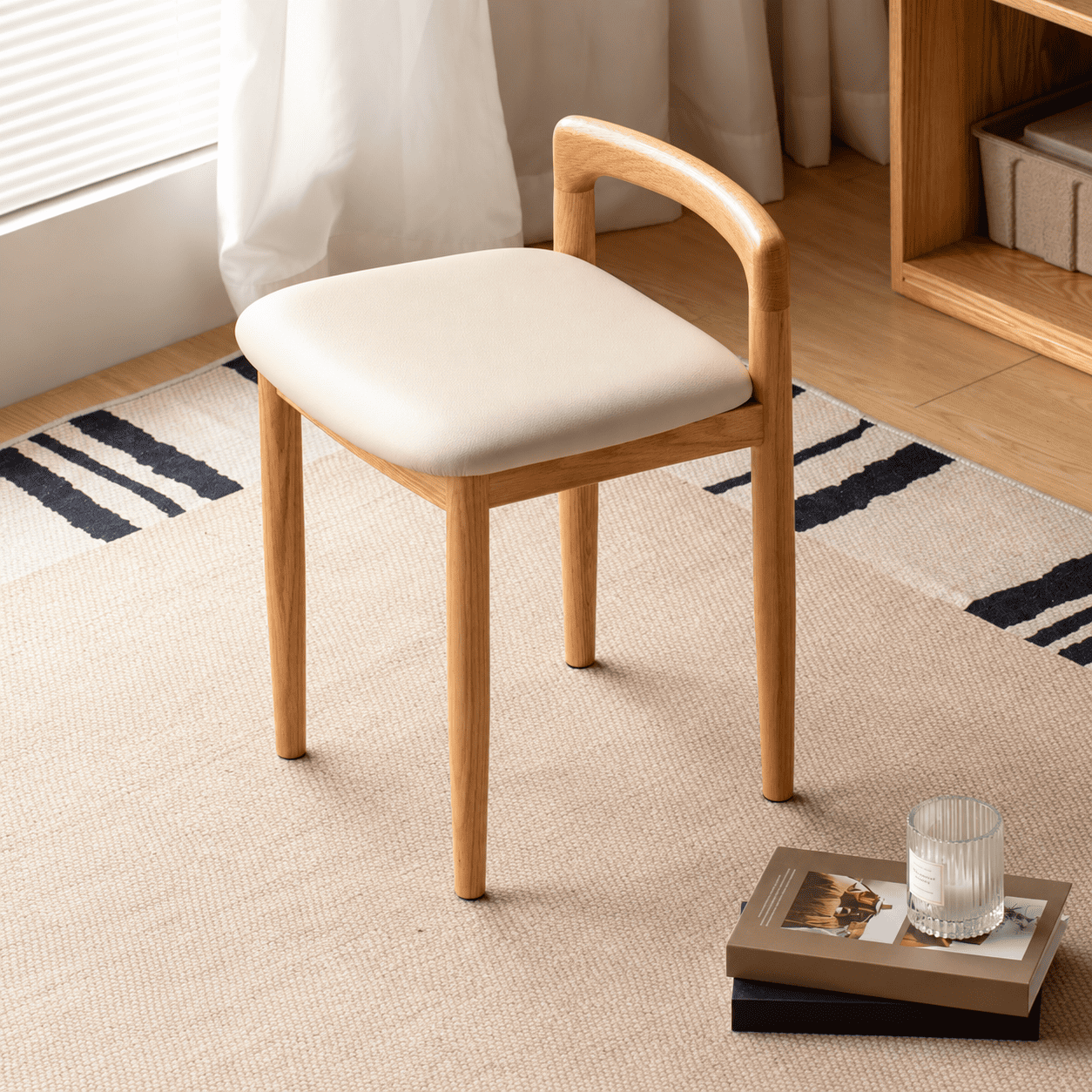 Nampa oak dressing stool with cream cushioned seat placed near window blinds in a bright room