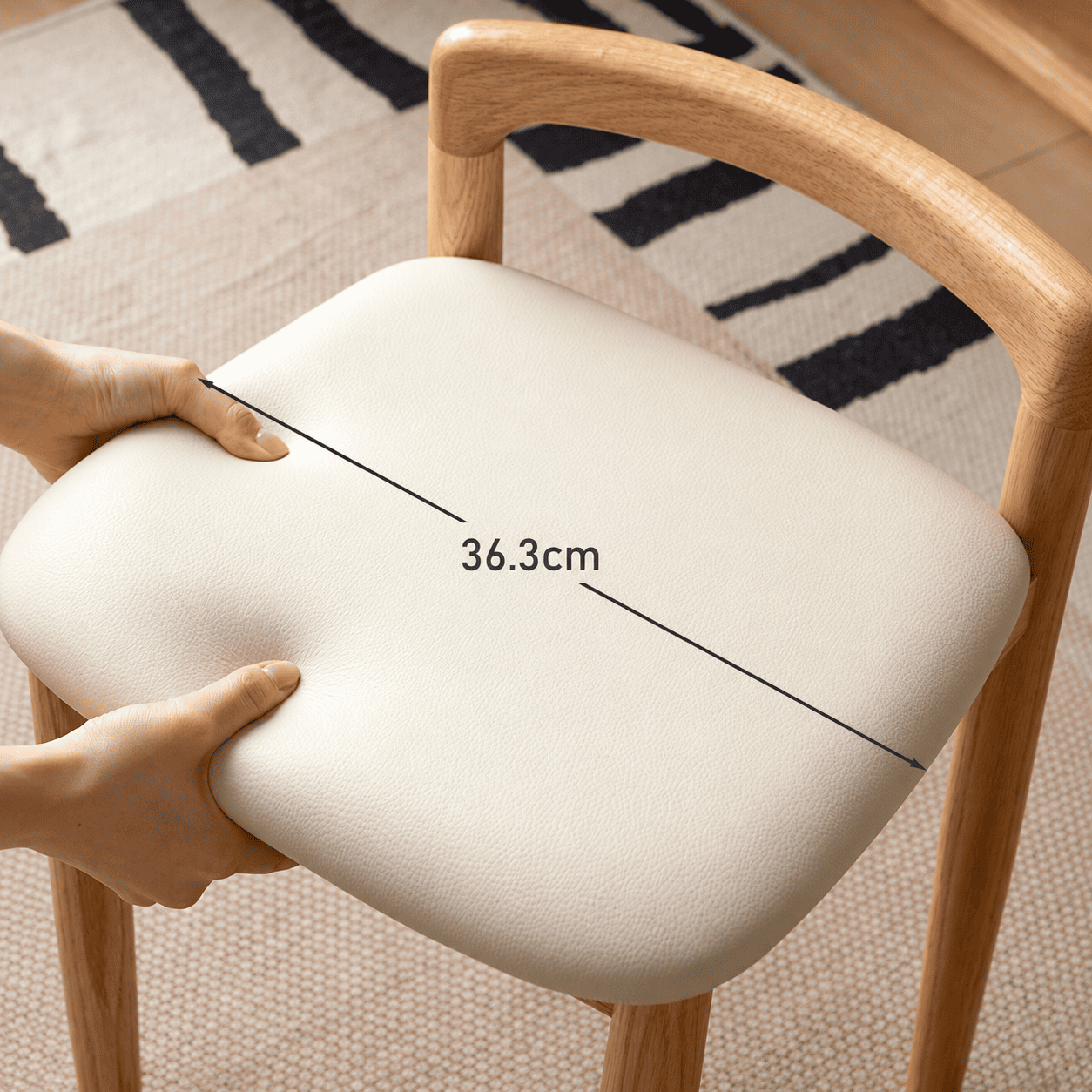 Close up of Nampa oak dressing stool cream cushioned seat and rounded solid wood backrest