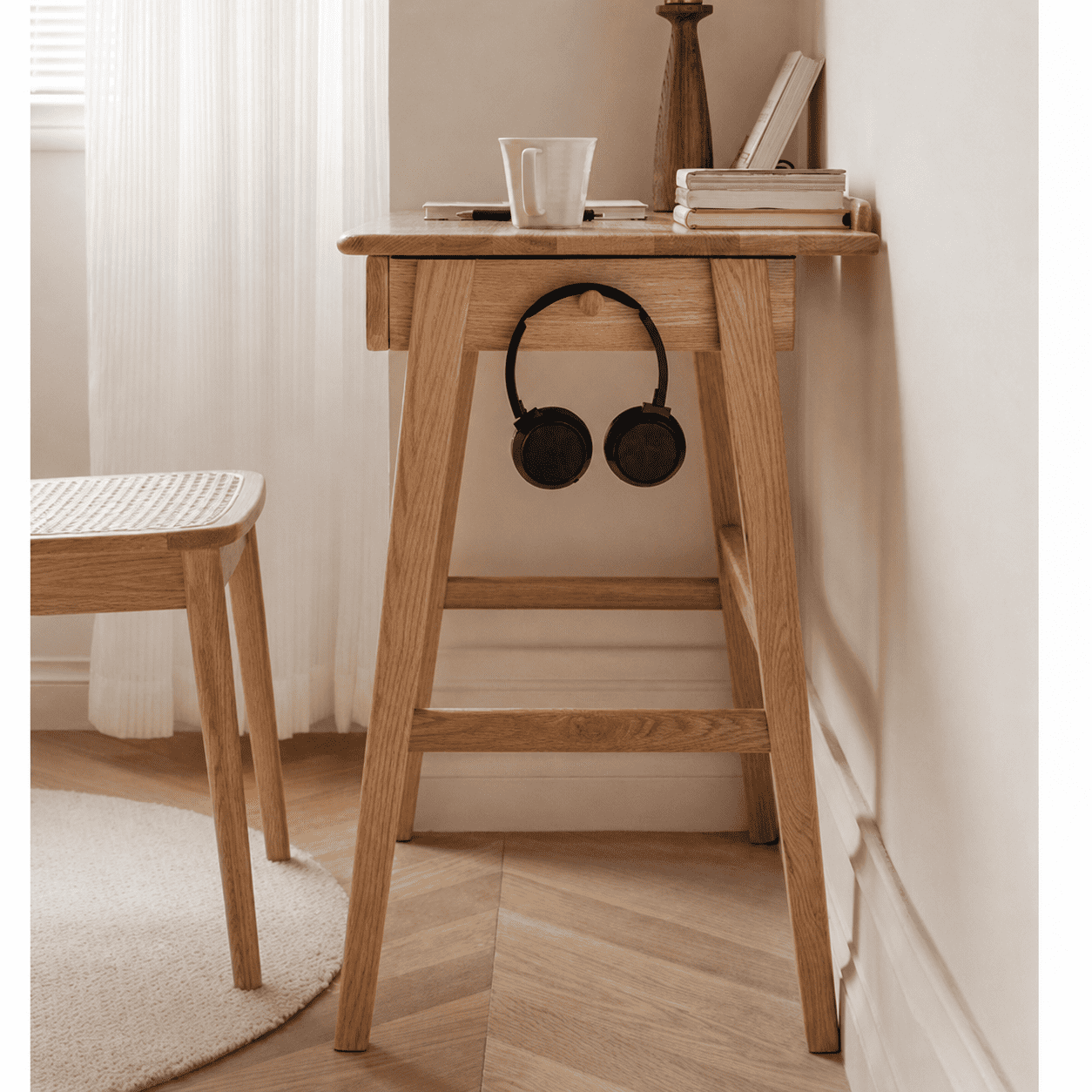 Scandinavian-style wooden side table with a single drawer and solid oak construction for versatile home use.