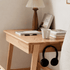 Modern oak bedside table featuring a storage drawer, open leg design, and natural wood finish.
