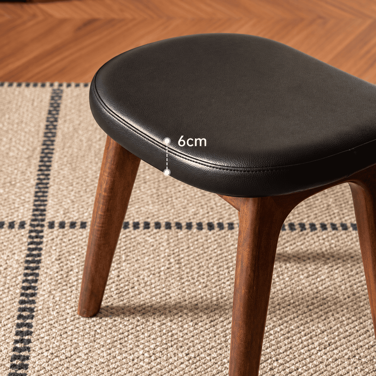 Norman black upholstered walnut dressing stool detail image showing 6cm cushion thickness