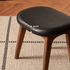 Norman black upholstered walnut dressing stool detail image showing 6cm cushion thickness