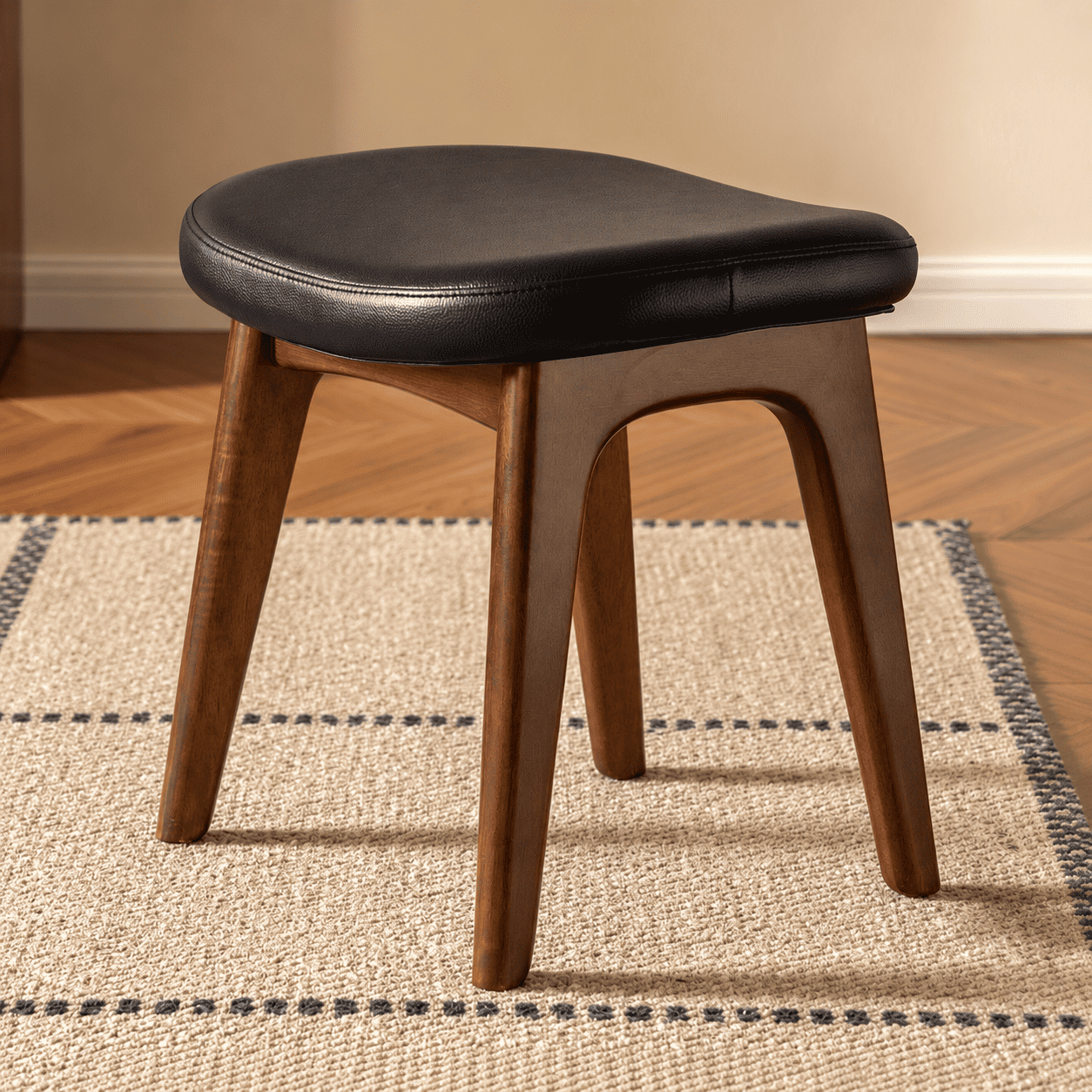 Norman natural solid walnut stool with black padded seat and rounded walnut legs