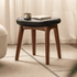 Norman walnut dressing stool with black cushion styled as a small side stool beside sheer curtains