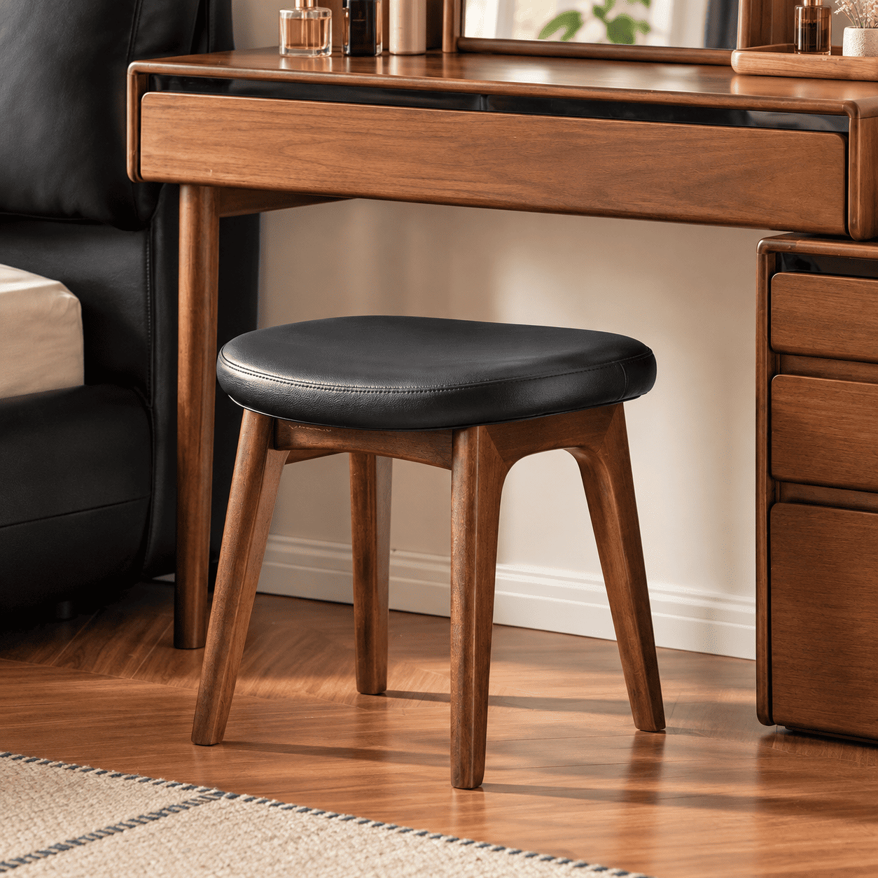 Norman black upholstered walnut dressing stool styled beneath a matching solid wood vanity table