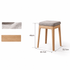 Light oak nesting stools with cushioned fabric seats for compact and versatile seating.