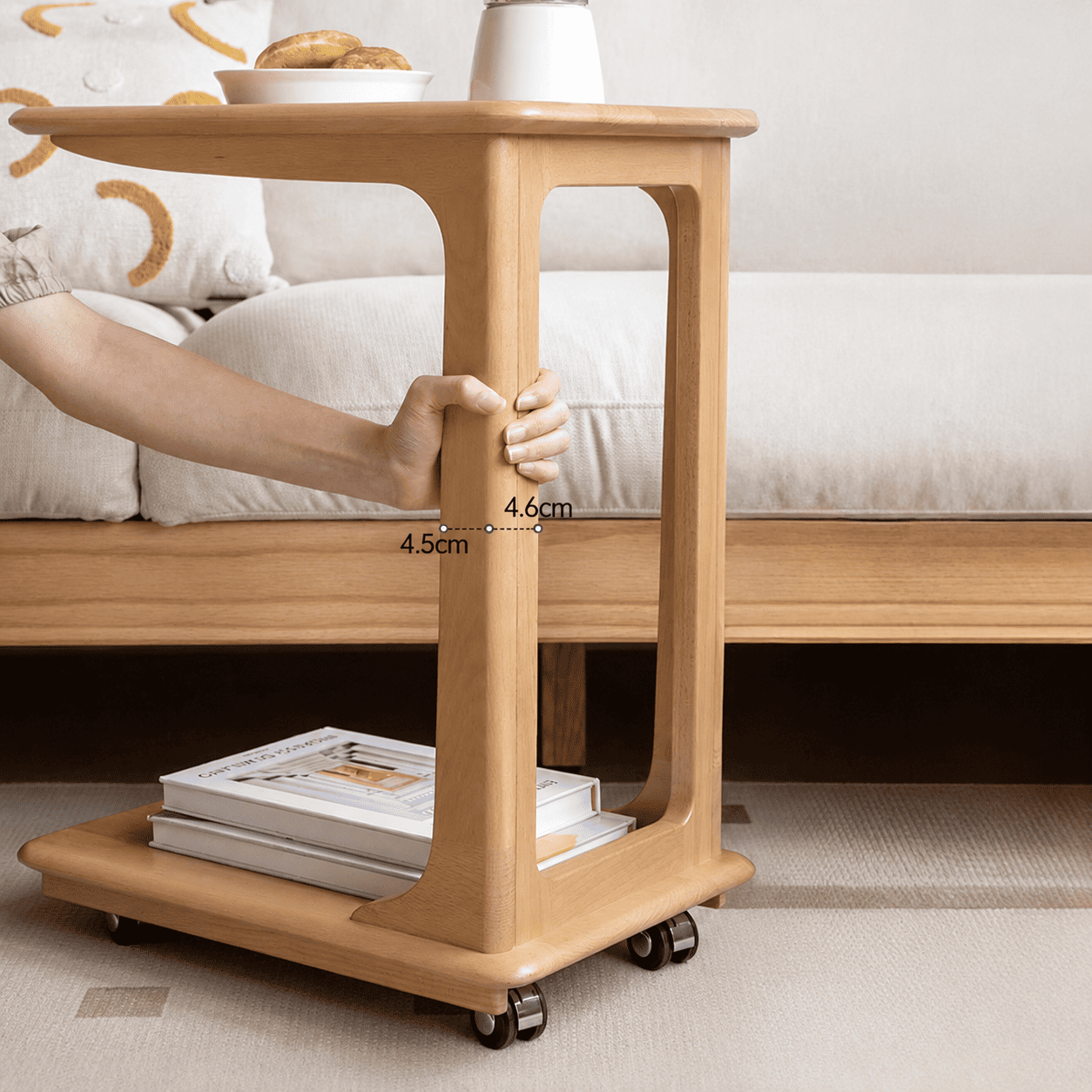 Light wood rolling side table with a minimalist frame and practical two-tier storage design.
