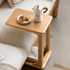 Contemporary rolling end table in a light oak finish with an integrated lower shelf.