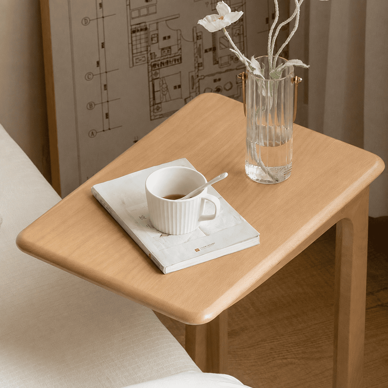 Mobile oak accent table with an open storage shelf for books and everyday essentials.