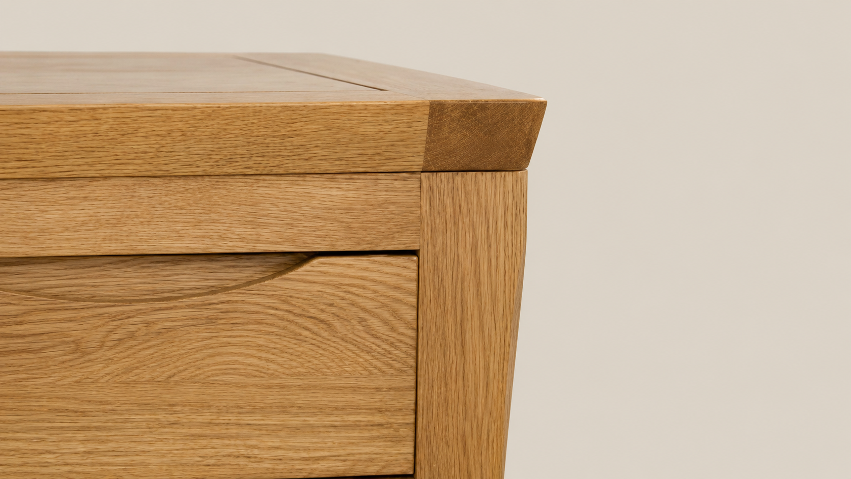 Close-up of the Renwick Rustic Oak Furniture Collection showing warm rustic oak grain, framed cabinet detail, and recessed drawer pull