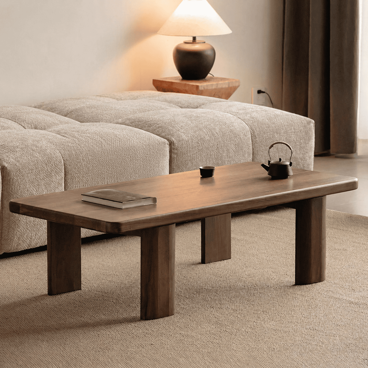 Ribera Natural Solid Walnut Coffee Table with rounded rectangular top, dark walnut finish and sturdy block legs in modern living room setting
