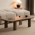 Ribera Natural Solid Walnut Coffee Table with rounded rectangular top, dark walnut finish and sturdy block legs in modern living room setting
