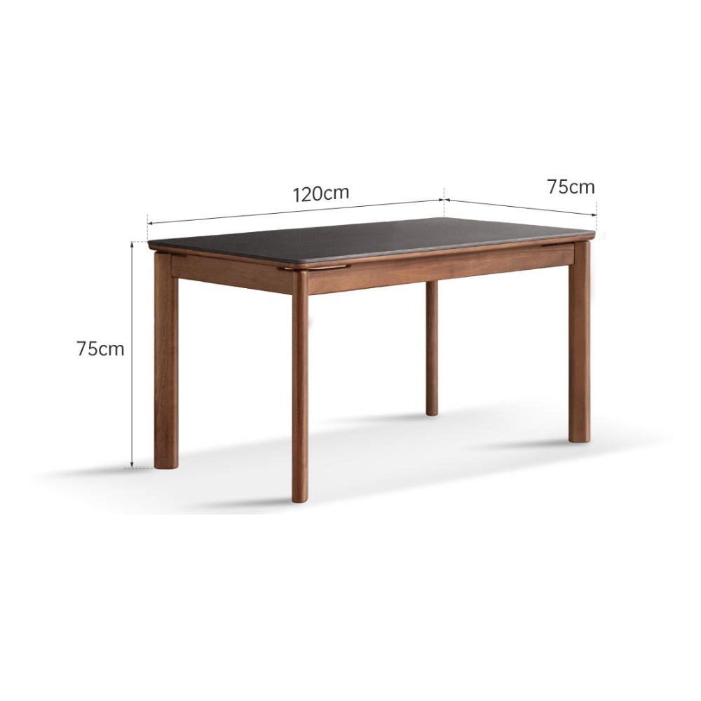 Walnut dining table with ceramic top styled with books, coffee set, and table lamp