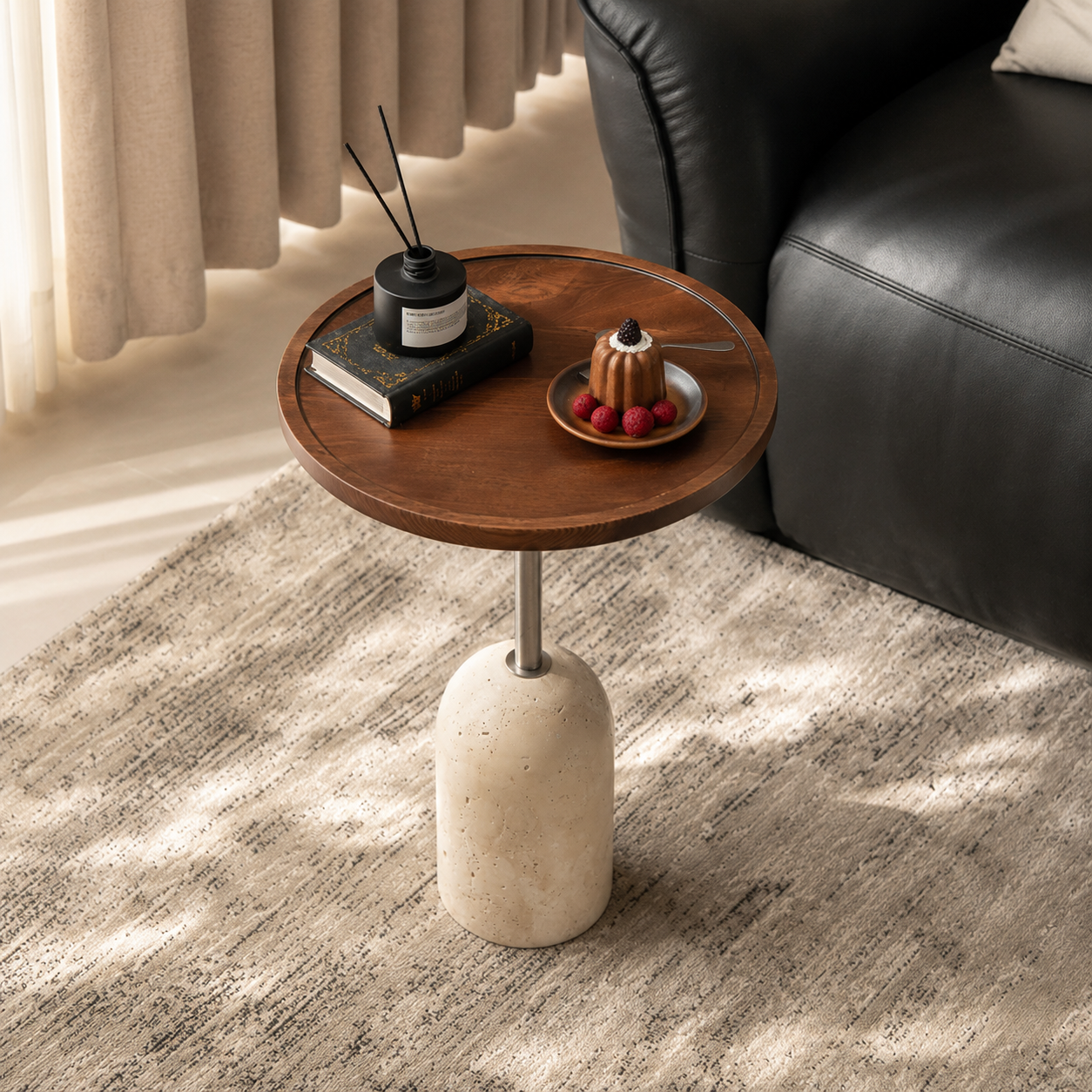 Top angled view of a round walnut side table with raised rim, metal stem and travertine base.