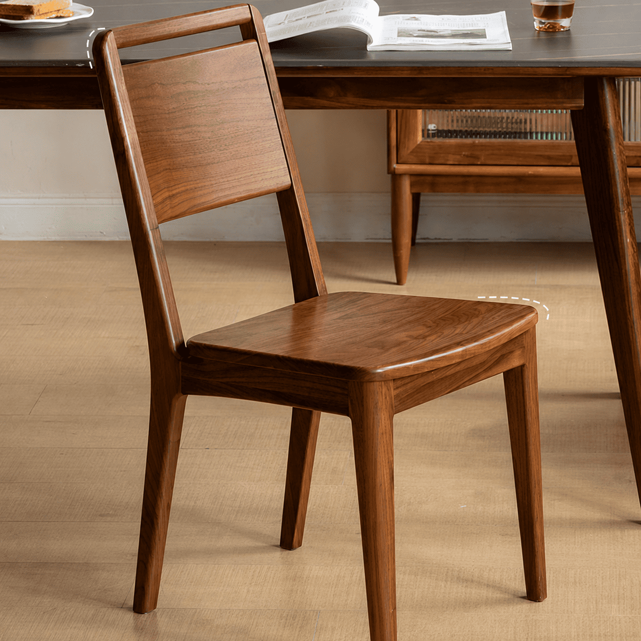 Natural solid walnut dining chair with curved wooden seat and slim timber backrest