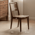 Solid walnut timber dining chair with warm brown finish and elegant wood grain texture