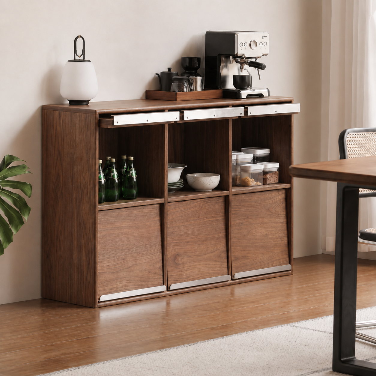 Three-section walnut sideboard with open storage and sliding wood panels used as a home coffee station.