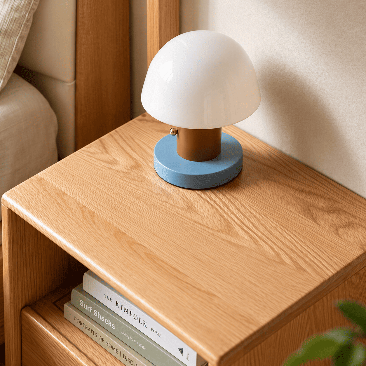 Close up of solid oak storage top with tray, books and natural wood grain detail